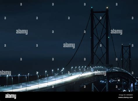 Forth Road Bridge at night with a blue colour cast Stock Photo - Alamy