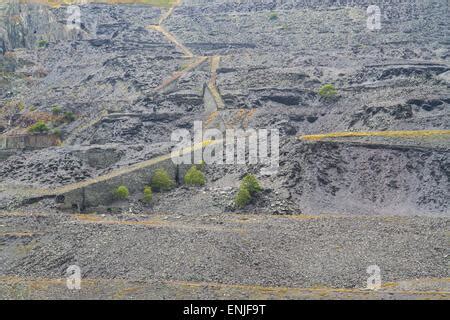 Flooded & disused slate quarry on island of Easdale in western Scotland with the village of ...