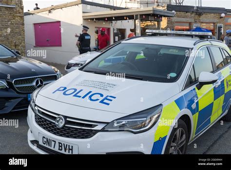 Marked Kent Police cars attended an incident at Margate Pier sea front, Kent, England Stock ...