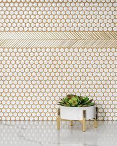 White penny tiles accented with gold grout are complemented with gold ...