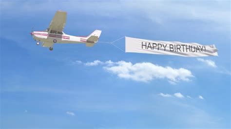 Small Propeller Airplane Towing Banner with HAPPY BIRTHDAY Caption in the Sky, Motion Graphics