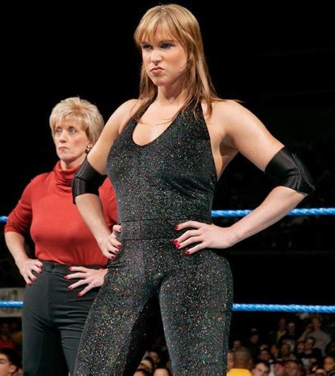 two women are standing in front of an audience wearing black and silver ...