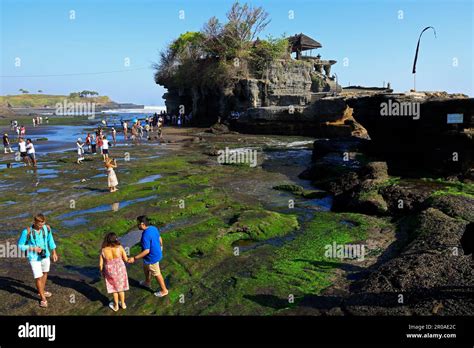 Tabanan, Bali, Indonesia - September 3, 2019: Famous Tanah Lot temple with visiting tourists ...