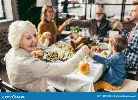 Family Holding Hands and Praying on Thanksgiving before Stock Photo ...