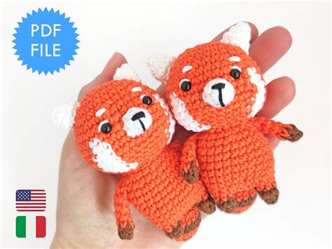 two crocheted stuffed animals sitting on top of each other in their hands,
