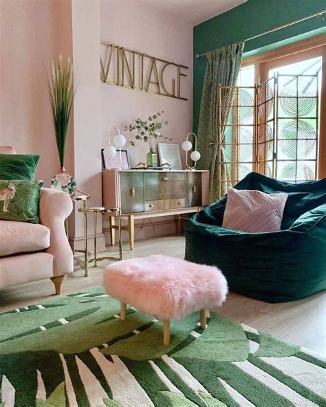 a living room with green and pink furniture, rugs and pillows on the floor