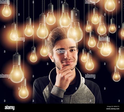 Young smart boy illuminated by light bulbs. Concept of creativity idea Stock Photo - Alamy