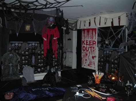 a living room decorated for halloween with decorations on the walls and ...