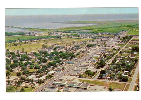 Chrome postcard. City of Clewiston looking east showing Clewiston Inn and Lake Okeechobee ...