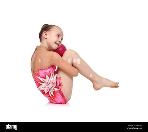 Little girl gymnast in red clothes posing with the ball Stock Photo: 106076465 - Alamy