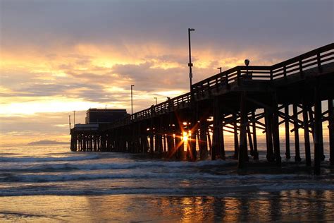 Newport Beach Pier Sunset with Sunburst Photograph by Keith Moore