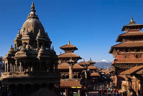 Temples in Patan | Himalayan mountains in the background. | Om Yadav ...