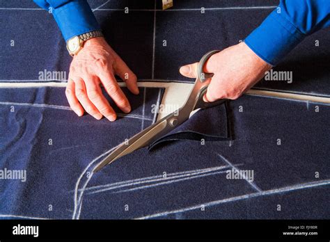 Tailor Cutting Fabric to a New Coat with Scissors Stock Photo - Alamy