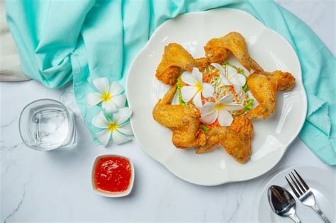 Free Photo | Fried wings with fish sauce, beautifully decorated and served.