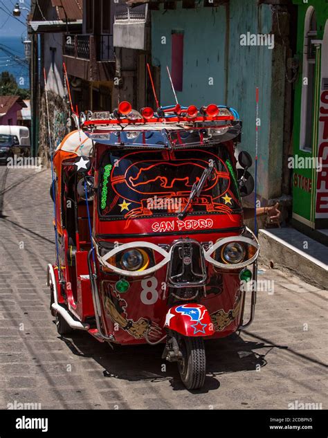 A highly decorated and customized tuk tuk or mototaxi in San Pedro la ...