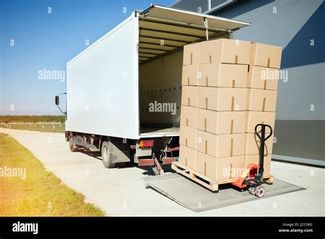 Truck transporting goods packed in boxes from warehouse Stock Photo - Alamy