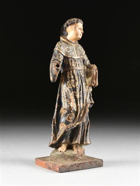 A SPANISH COLONIAL POLYCHROME AND CARVED WOOD SANTO FIGURE O