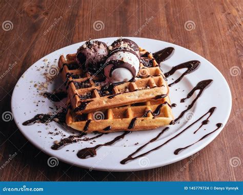 Belgian Waffles with Ice Cream. Chocolate and Nuts. Wooden Table Stock ...