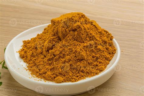 Curry powder on wooden background 10865497 Stock Photo at Vecteezy