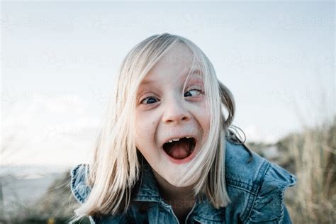 Image of Young girl doing a funny face - Austockphoto