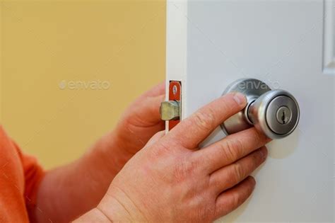 Installation of the door lock. installation of a lock at the door Stock Photo by photovs