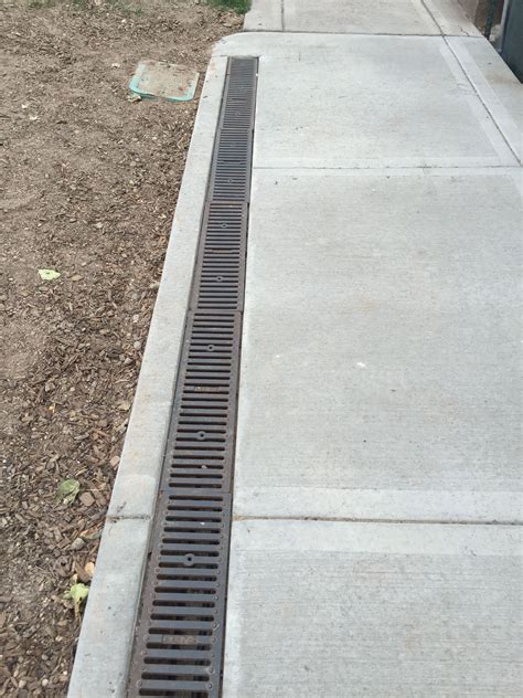 Sidewalk with built-in drain and snowmelt system. | Drainage solutions, Backyard drainage, Yard ...