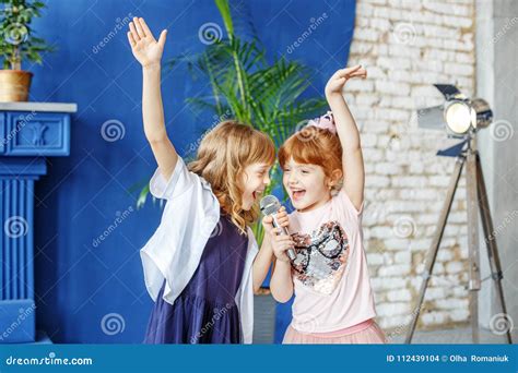 Two Little Funny Children Dance and Sing a Song in Karaoke. the Stock Photo - Image of karaoke ...