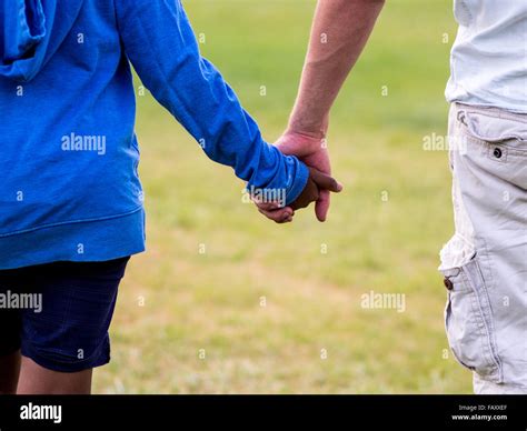 Friends holding hands Stock Photo - Alamy