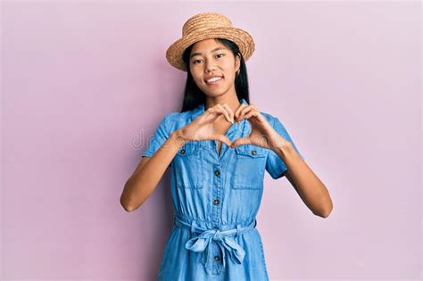 Young Chinese Woman Wearing Summer Hat Smiling in Love Doing Heart ...