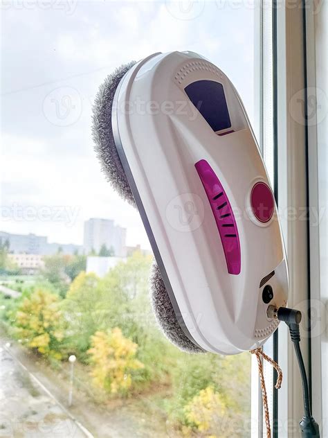 Vacuum cleaner robot washing glass window. Robot window cleaner 12813125 Stock Photo at Vecteezy