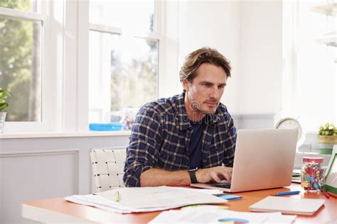 Man Sitting at Desk Working at Laptop in Home Office Stock Image ...