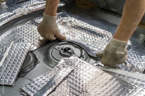 Foto de Process of installation of soundproofing material to inside of car. Auto sound ...