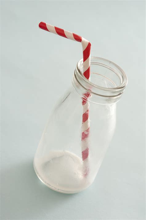 empty glass milk bottle with straw - Free Stock Image