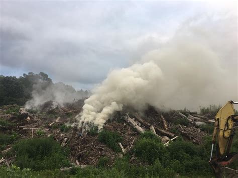 Mulch pile fire continues to smolder in Newtown