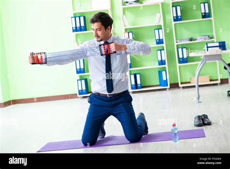 Employee doing exercises during break at work Stock Photo - Alamy