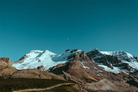 a majestic alpine landscape of rocky mountains covered in snow, alpine ...