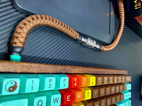 a computer keyboard sitting on top of a wooden shelf