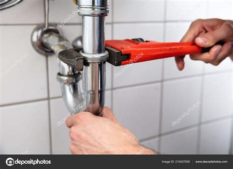 Close Plumber Hand Repairing Sink Adjustable Wrench — Stock Photo © AndreyPopov #210437050