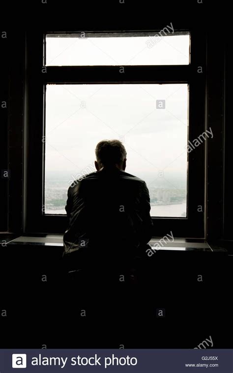 Silhouetted Man Looking Out Window Stock Photo | Hombre sentado ...