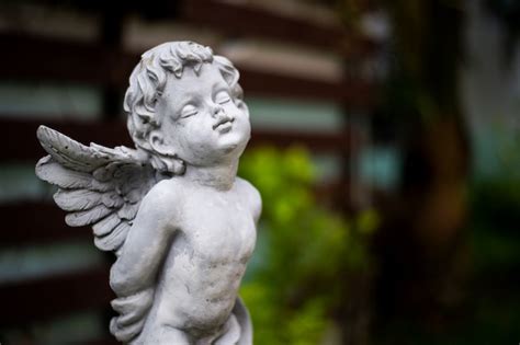 Premium Photo | Closeup cupid sculpture in garden