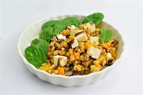 Close Up Food Photo of Pearl Barley with Feta Cheese and Spinach in a White Ceramic Bowl on ...
