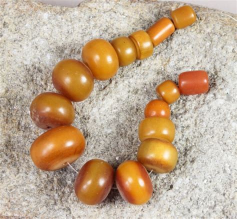 11 African amber beads (phenolic resin)