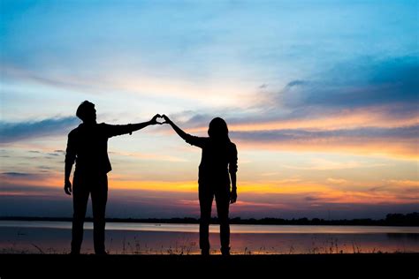 Silhouette of young couple during sunset 1959687 Stock Photo at Vecteezy