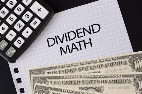 Calculator, money and Dividend Math text on black table - Creative ...