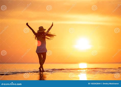 Young Happy Girl at Sunset Beach with Raised Arms Stock Photo - Image of healthy, landscape ...