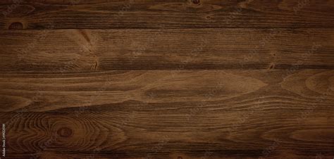 Dark stained wood boards with grain and texture. Flat wood background with parallel horizontal ...