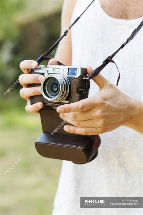 Man holding vintage camera in forest — memories, person - Stock Photo ...