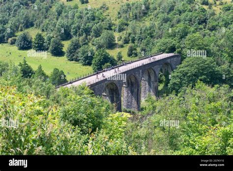 Cyclists and Walkers crossing Headstone Viaduct (Monsal Viaduct) part of the Monsal Trail seen ...