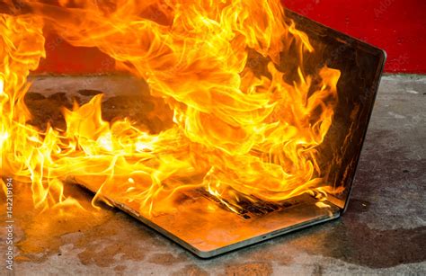 Laptop computer on fire and burning furiously Stock Photo | Adobe Stock