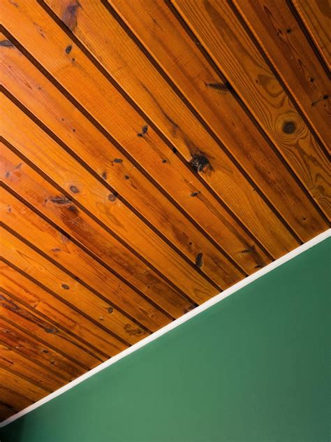 a green wall and wooden ceiling in a room